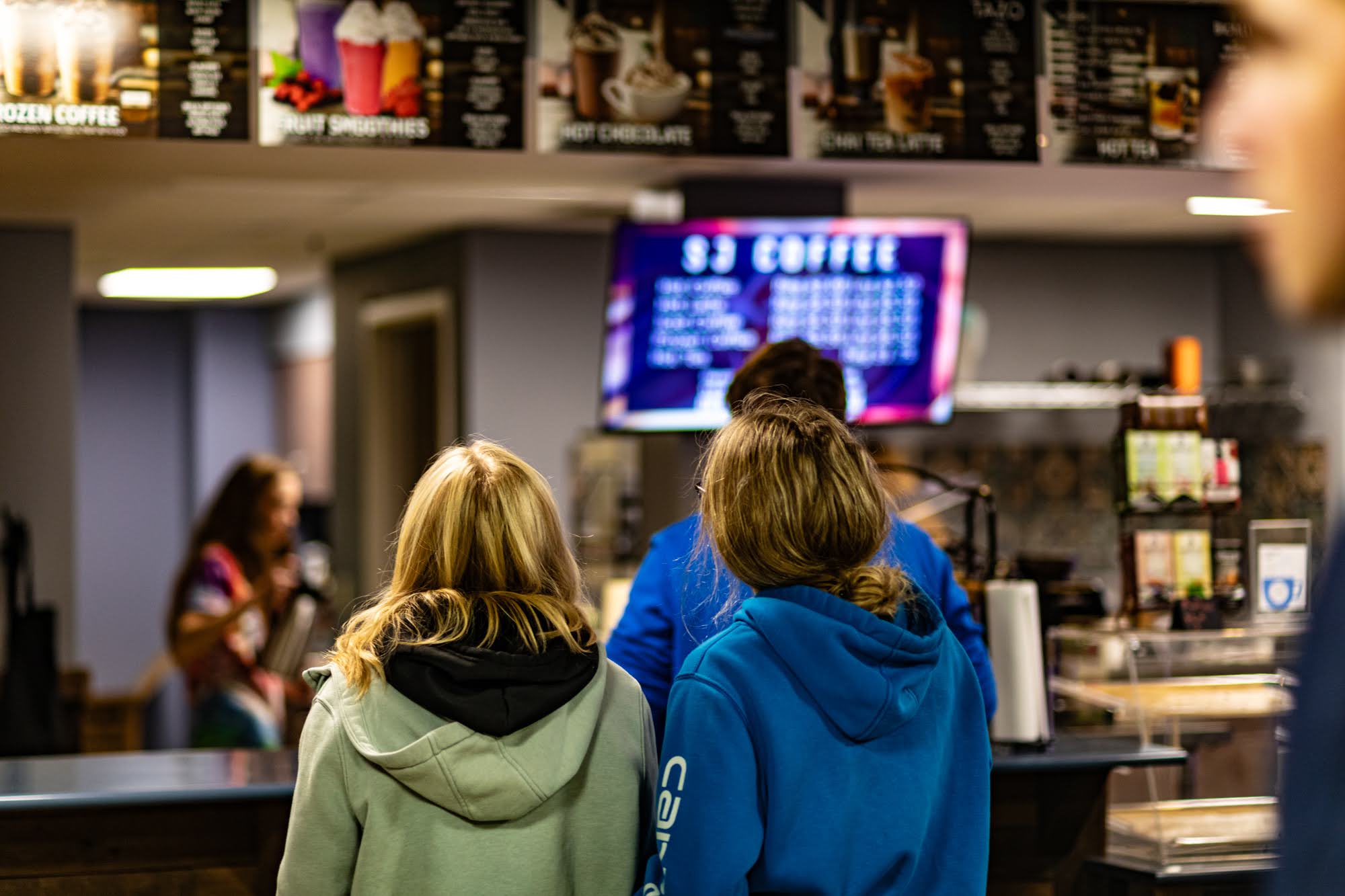 People gathered at a café counter.